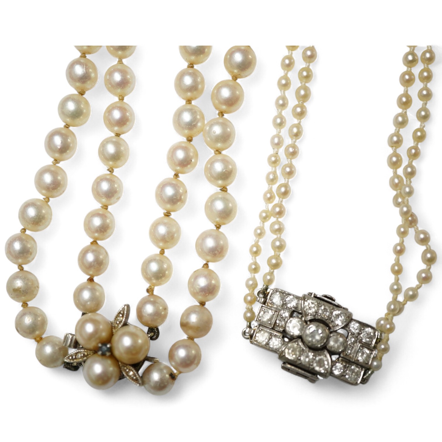 Two double strand cultured pearl necklaces, one graduated with paste set white metal clasp, 48cm, the other with cultured pearl set 9ct white gold clasp.